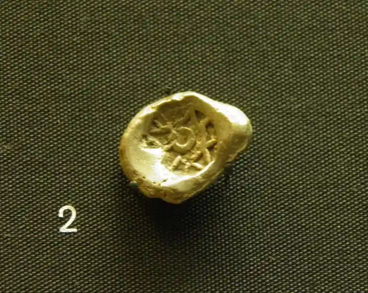 Four-point star with a circle inside engraved on a coin in trade